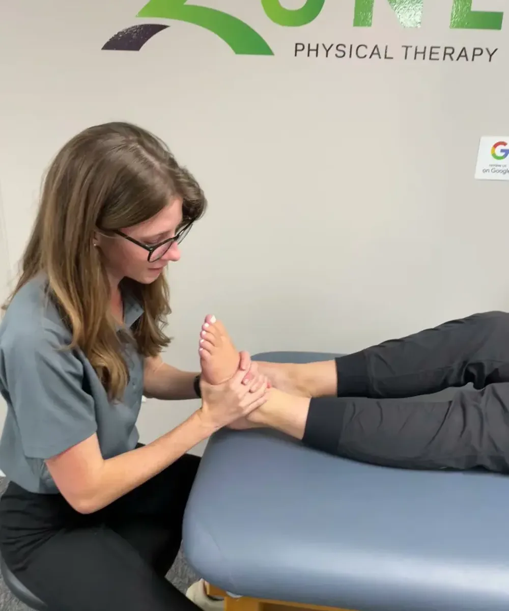 A Doctor of Physical Therapy evaluating a patient at Zone Physical Therapy in Greer, SC